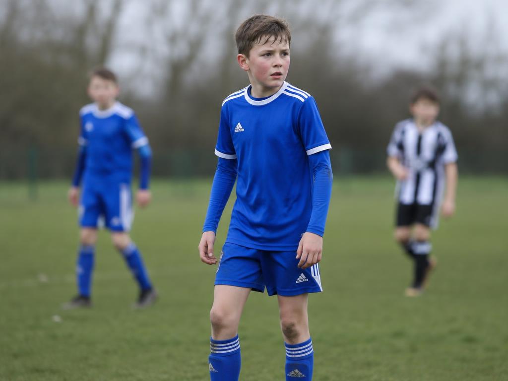 A young footballer looking focused during a match